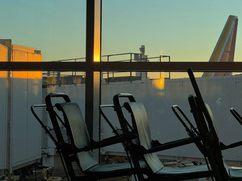 Airport terminal view with plane tail and sunset glow