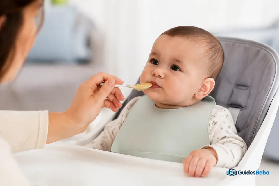 Baby trying first foods from a spoon