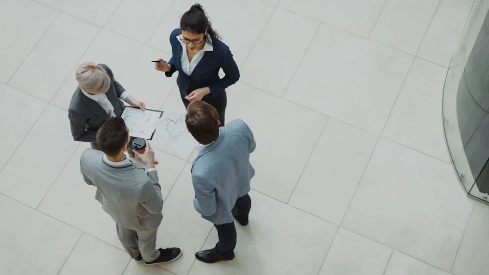 Four business professionals collaborating in a modern office space
