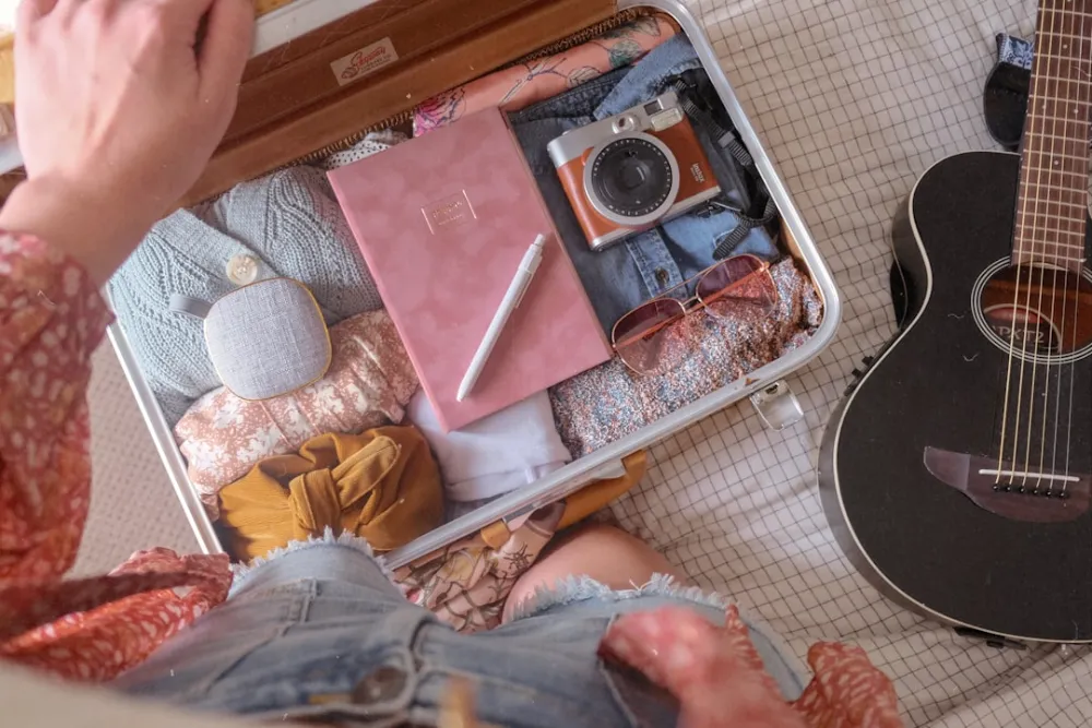 a person sitting on the floor next to a guitar