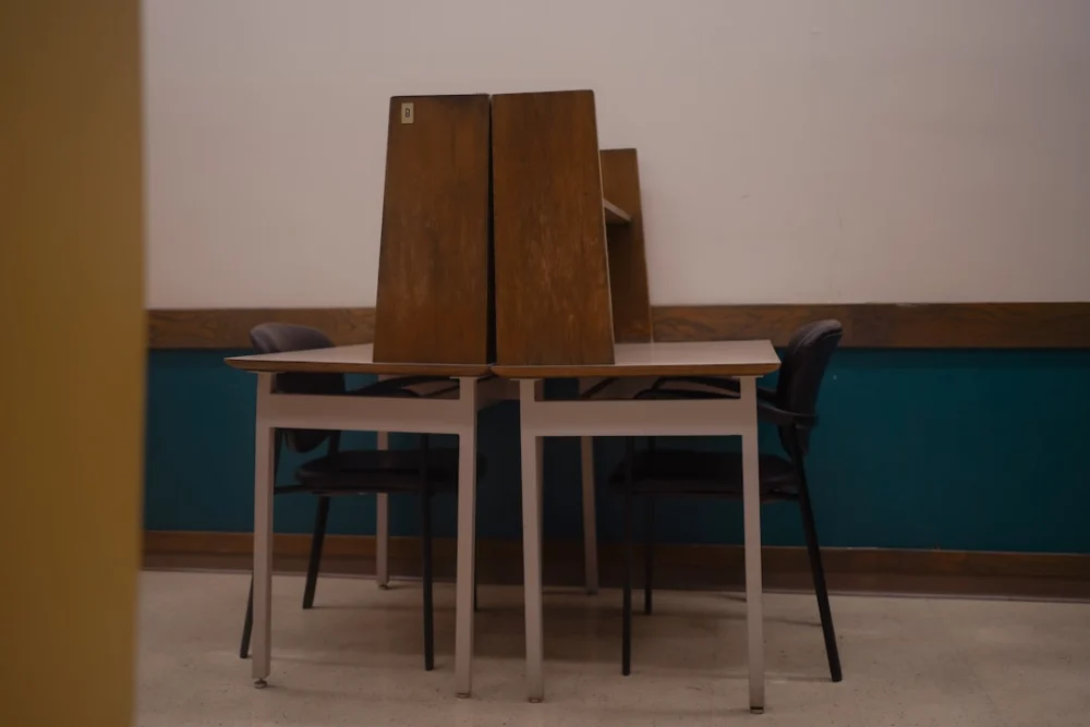 Two desks with chairs in a room