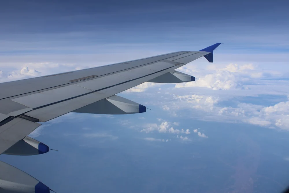 the wing of an airplane flying above the clouds