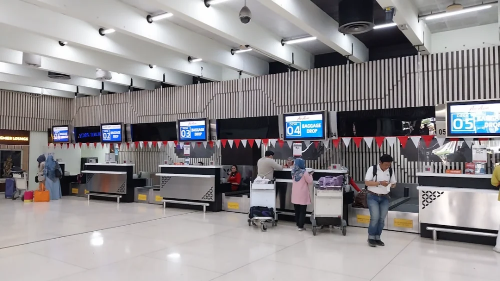 a group of people waiting in line at an airport