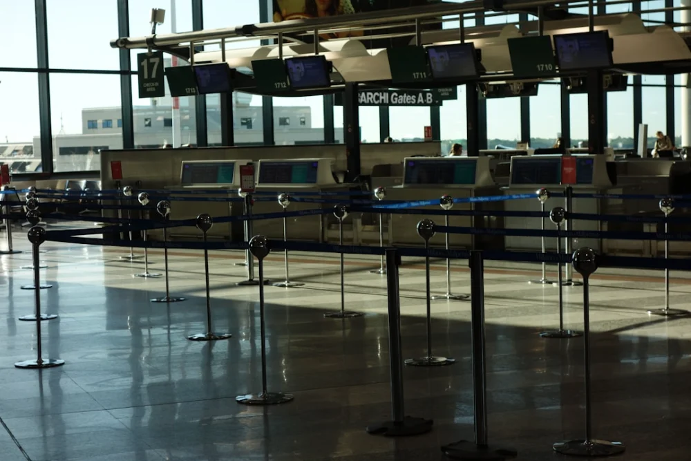 Empty airport check-in counters with stanchions