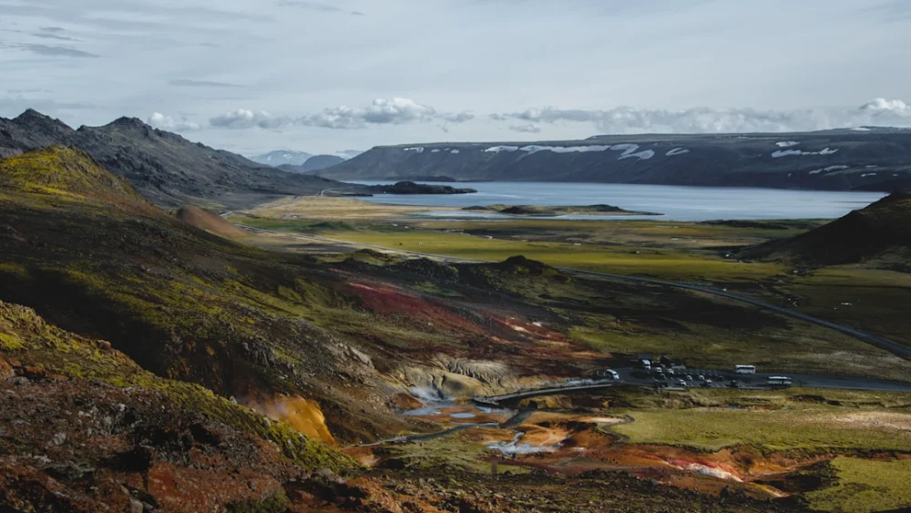 a scenic view of a valley and a body of water