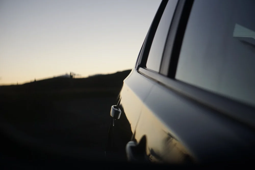 close-up photography of car door during sunset