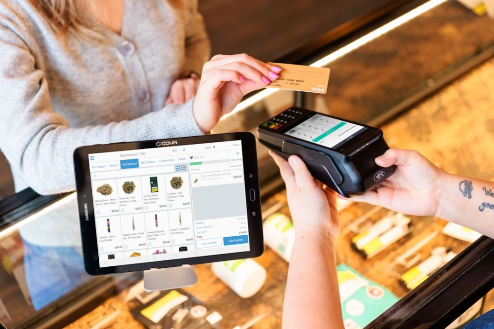 a woman is paying a card from a machine