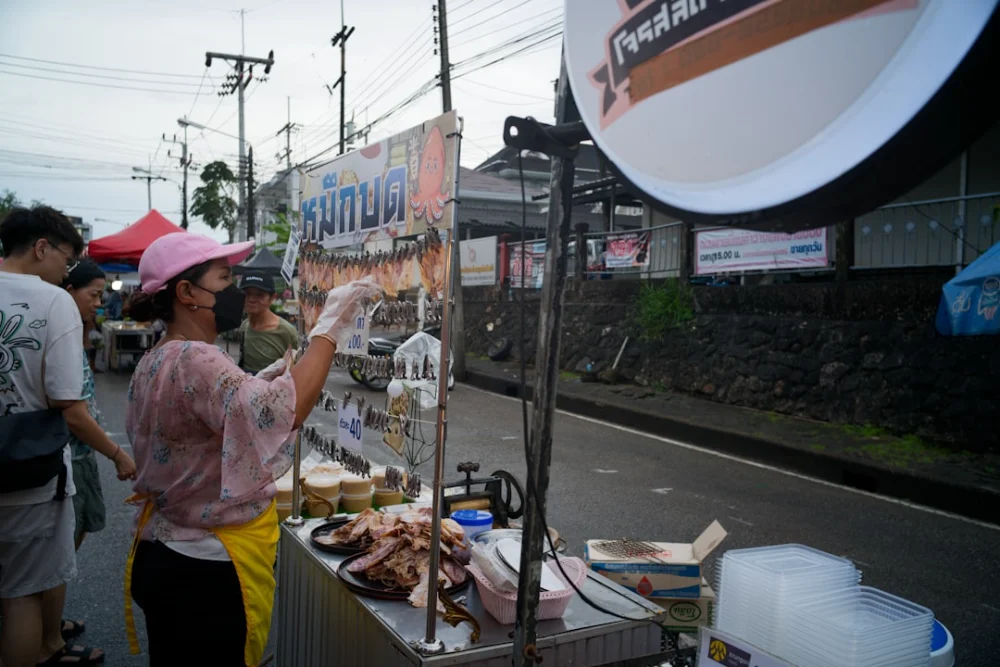 Vendor serves food at an outdoor market stall