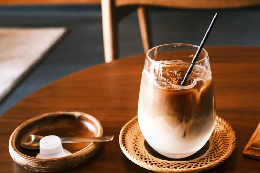 Iced coffee with cream and ice on a table