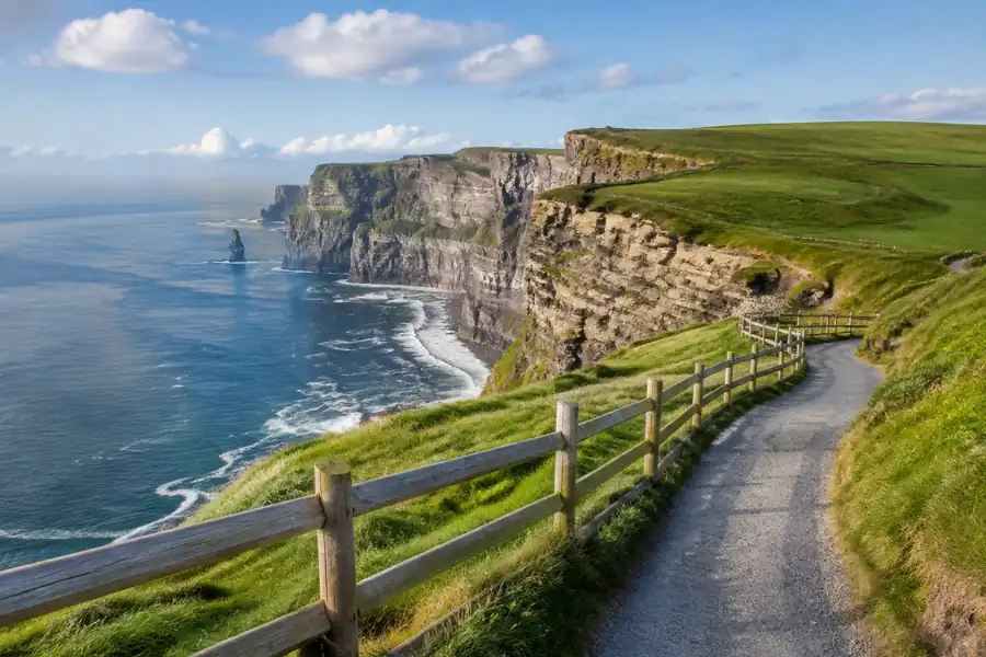 Irish coastal cliffs and fenced trail