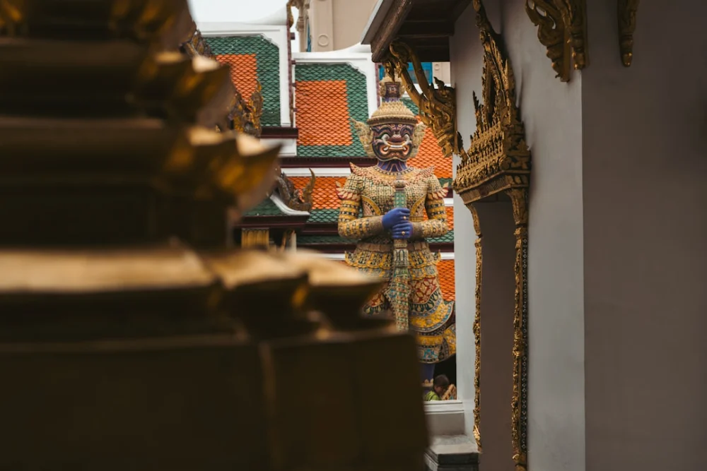 A golden statue of a mythical guardian stands outside