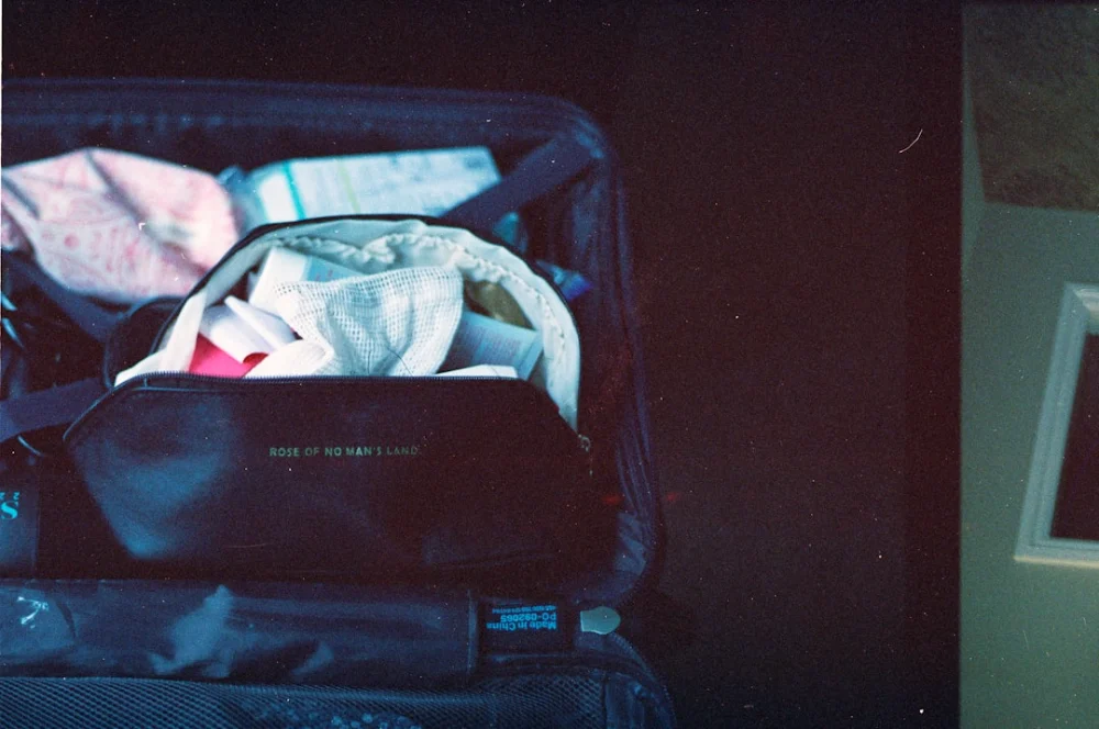 Packed suitcase with clothes and toiletries inside