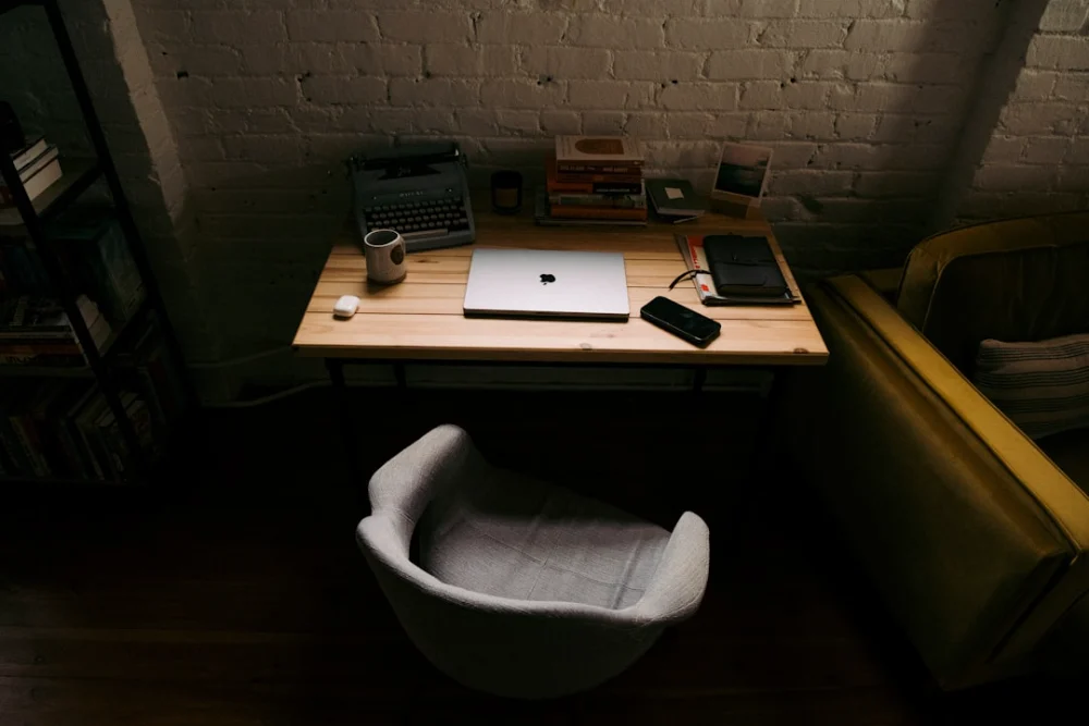 a laptop computer sitting on top of a wooden desk