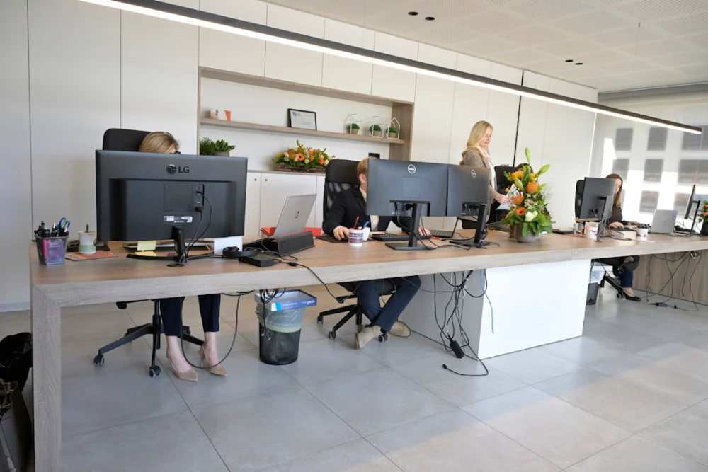 People working at desks in a modern open-plan office