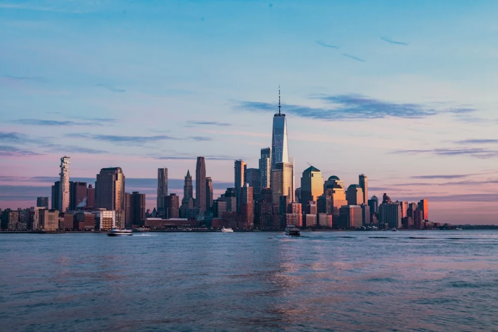 The New York City skyline across the Hudson River from Hoboken at golden hour