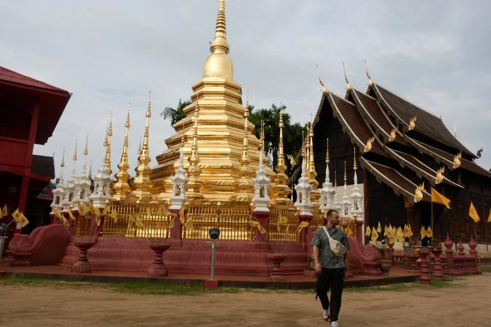 Golden temple with ornate spires and wooden building