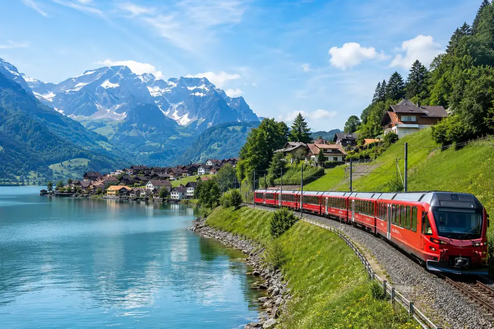 Swiss passenger train beside an alpine lake