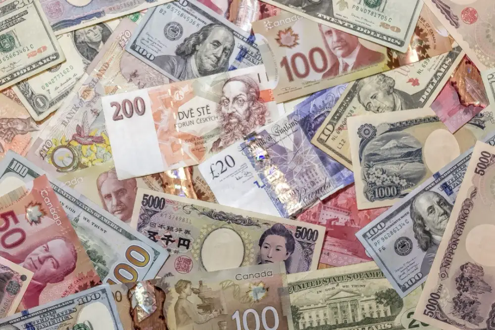 A chaotic pile of various international banknotes