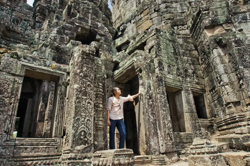 woman standing at ruined brick building