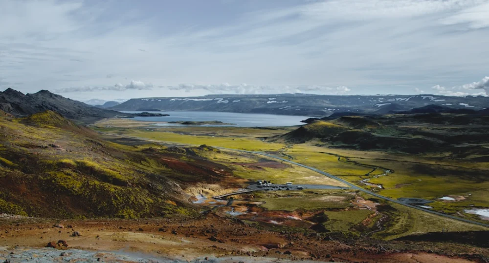 a scenic view of a valley and a body of water