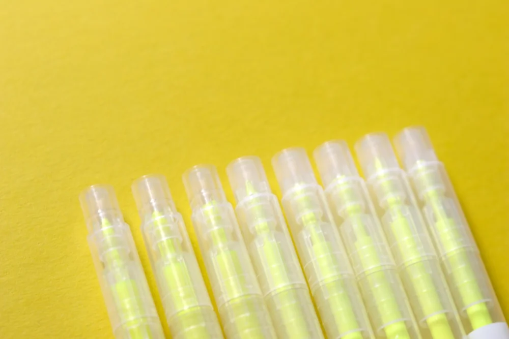 white plastic tube on yellow surface