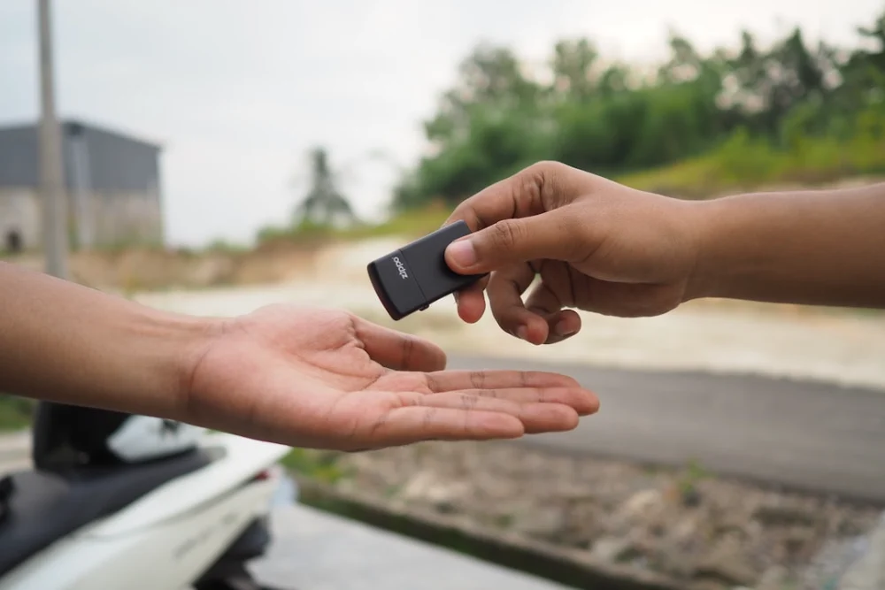 person holding black rectangular device