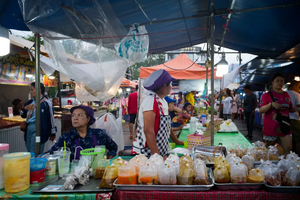 People at a busy outdoor food market stall