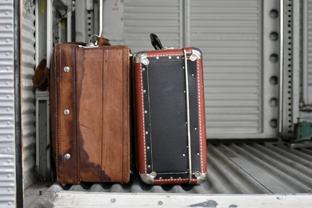 Two vintage suitcases on a ribbed surface