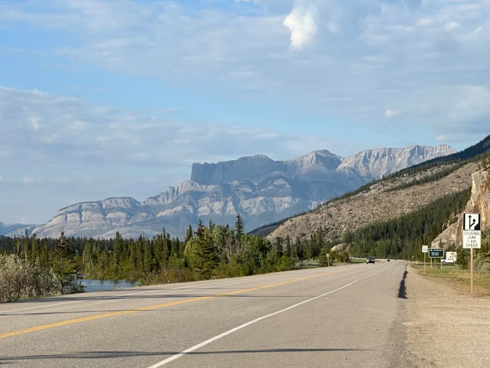 a road with a mountain in the background