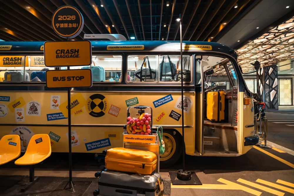 Vintage yellow bus decorated with stickers and luggage