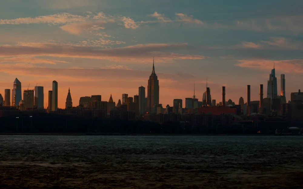 a city skyline with a body of water in the foreground