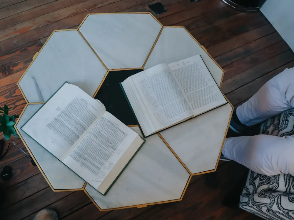 Books are open on a unique hexagon table