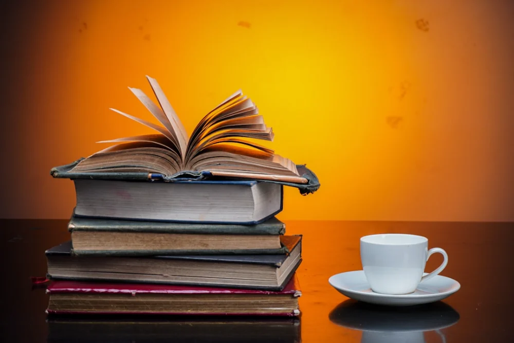 Stack of books with a cup of coffee