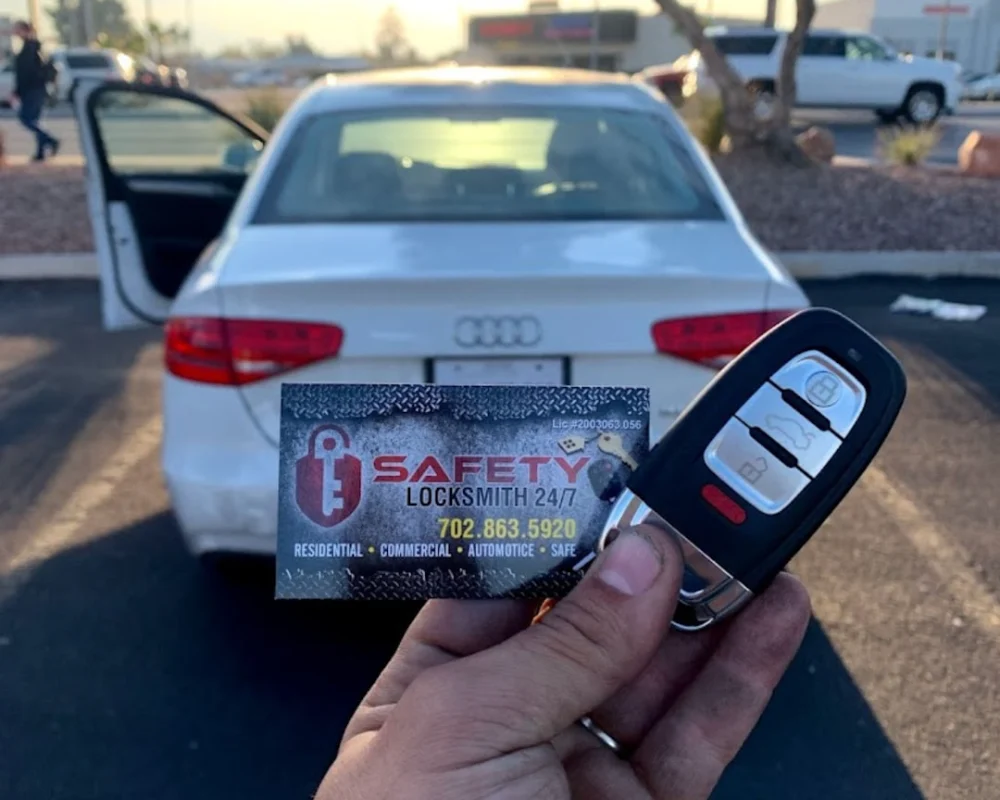 a person holding a car key in front of a white car